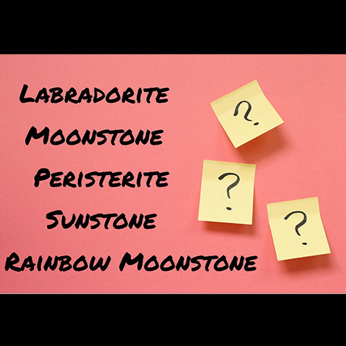 A pink card showing five mineral names, with three post-it notes on the right, each displaying a question mark.