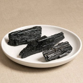 Three large raw black tourmaline crystals